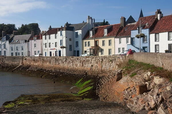 Harbour wall, low tide and pastel coloured cottages, St. Monan, East Coast, Fife, Scotland, United Kingdom, Europe