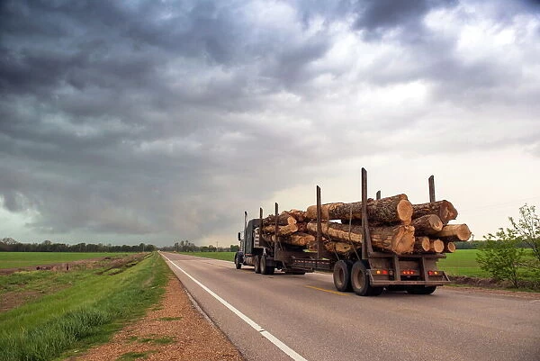 Logging truck in Mississippi driving into the heart of a thunderstorm with an extreme tornado watch, United States of America, North America