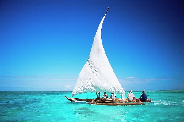 Outrigger canoe with sail on Indian Ocean, off Jambiani, Zanzibar, Tanzania