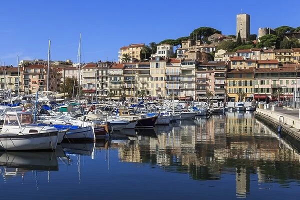 Reflections of boats and Le Suquet, Old (Vieux) port, Cannes, Cote d Azur, Alpes Maritimes