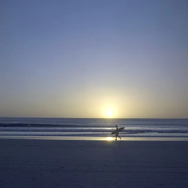 Silhouette of surfer walking on Avellanas Beach, Nicoya Peninsula, Costa Rica