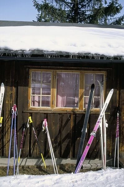 Skis outside wooden building