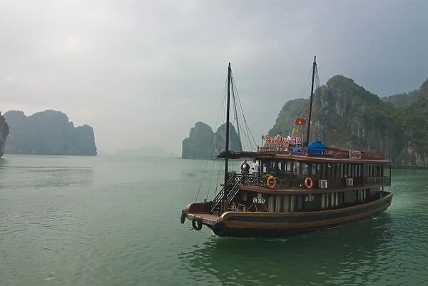 Tourist boat in a traditional style cruising the Halong Bay, Vietnam, Indochina