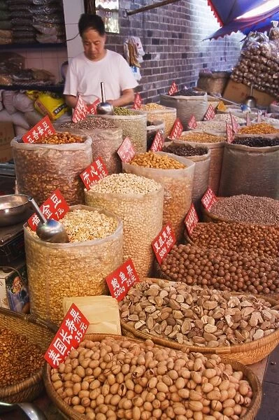 Vendor selling nuts at a market in the Muslim Quarter, home to the citys Hui community