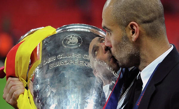 Barcelona manager Pep Guardiola kisses the Champions League trophy after victory over Manchester United at Wembley
