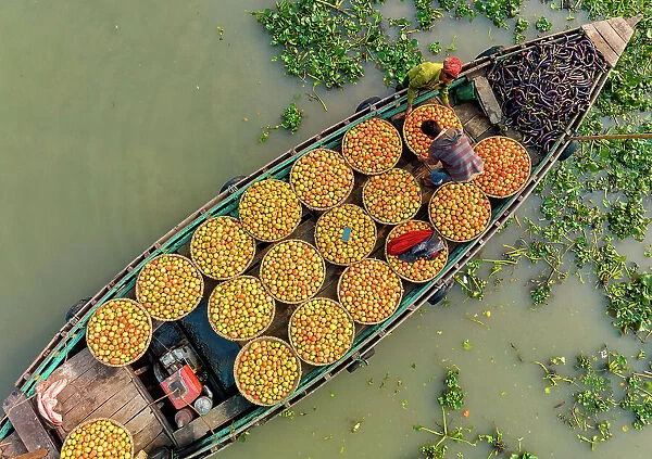 Aerial view of people trading with fruits and vegetables on boats along the river in Brahmanbaria, Bangladesh