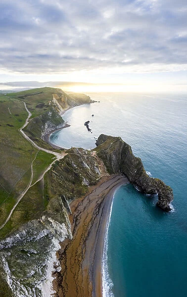 Aerial view at sunrise of the Durdle Door, a natural limestone arch on the Jurassic Coast