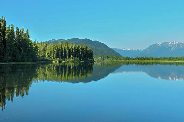 Coast Mountains reflected in Tattoga Lake near Iskut along the Stewart Cassiar Highway, British Columbia, Canada