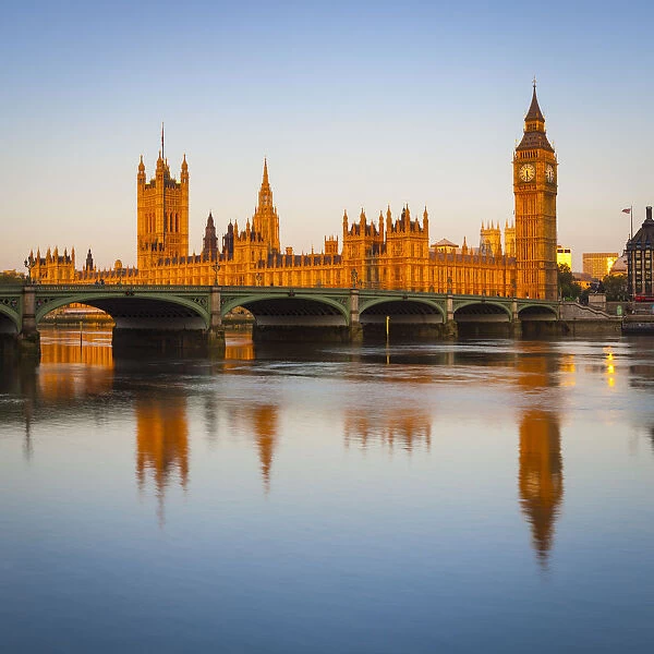 The Houses of Parliament & The River Thames illuminated at sunrise