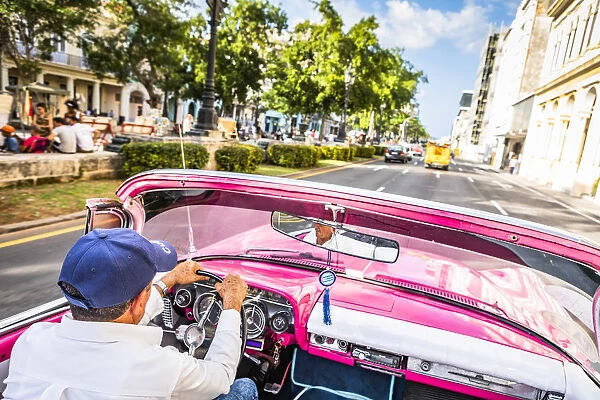 A man driving a classic car in Centro Habana District, Havana, Cuba