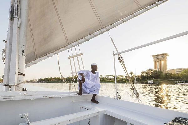 Nubian sailor on his felucca boat on the Nile River, Aswan, Upper Egypt, Egypt, Africa