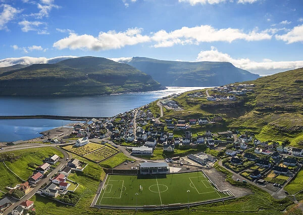 Panoramic aerial view of soccer field in the village of Eidi, Eysturoy island, Faroe
