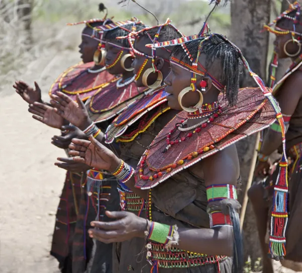 Pokot women wearing traditional beaded ornaments and brass earrings denoting their married status