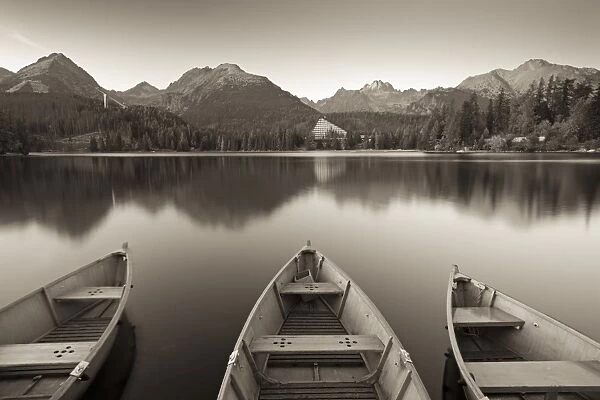 Rowing boats and mountains beneath a twilight sky, Strbske Pleso Lake in the High Tatras