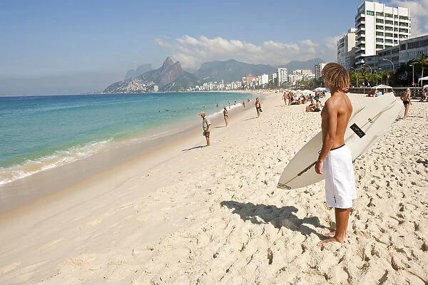 South America, Rio de Janeiro, Rio de Janeiro city, Ipanema, surfer with a surf board