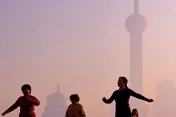 Tai Chi exercises at sunrise, The Bund, Shanghai China
