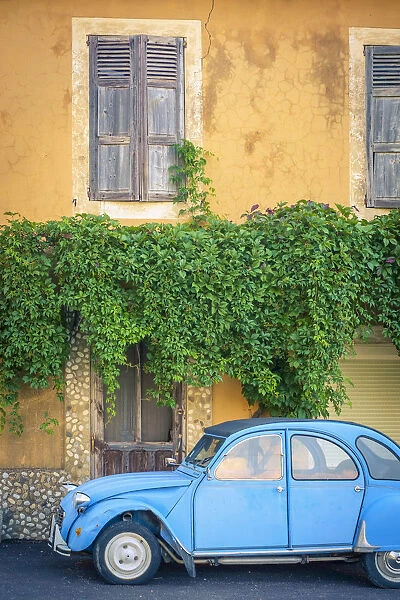 Vintage blue Citroen 2cv parked in front of a house in Castellet, Vaucluse