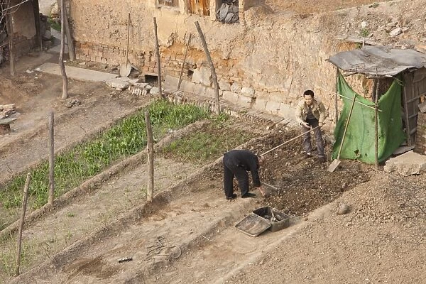 Chinese workers preparing their garden plot for food production near Tongshuan, Northern China