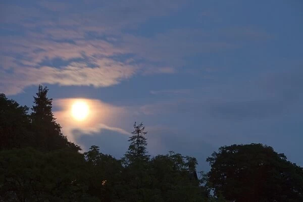 Moon behind thin cloud over Ambleside, UK