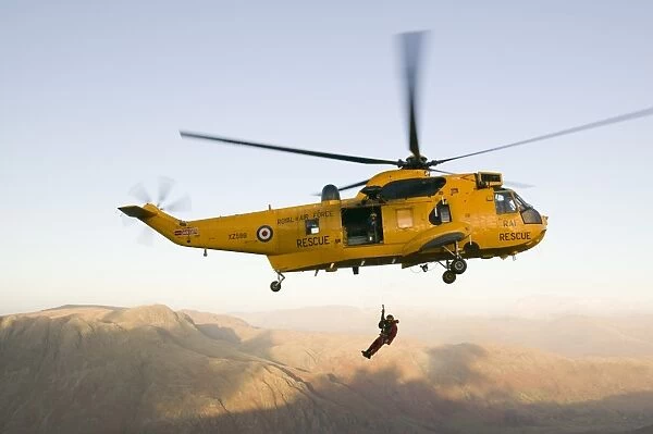 An RAF sea king helicopter attends a mountain rescue incident in the Lake District UK