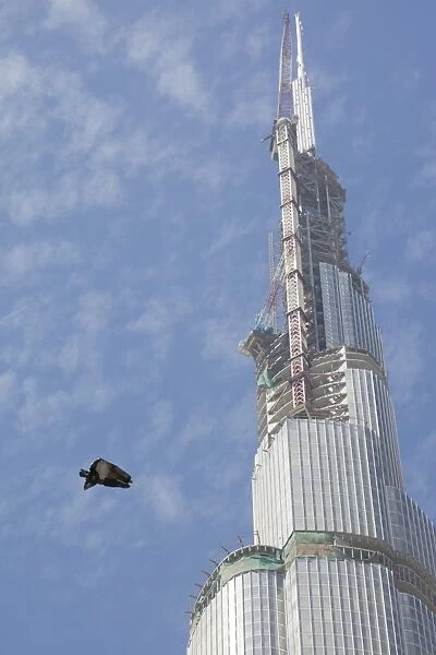 Rubbish floating past the burj Dubai the worlds tallest building in Dubai