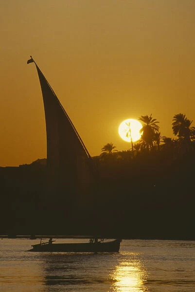 10060885. EGYPT Aswan Felucca on the River Nile at sunset
