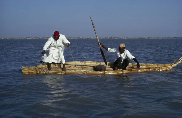 20040119. CHAD Lake Chad Two Buduma tribesmen fishing in a reed boat on the lake