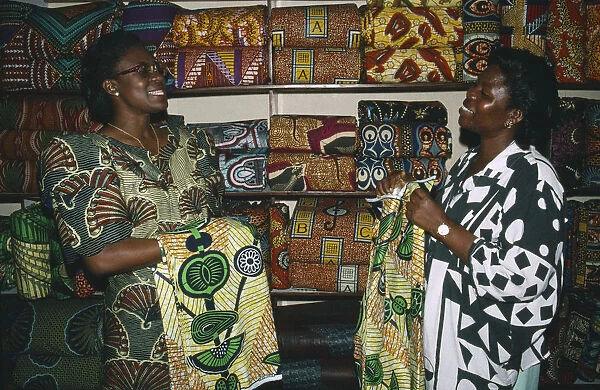 20061178. TOGO Lome Female cloth vendors selling traditional cloth at market