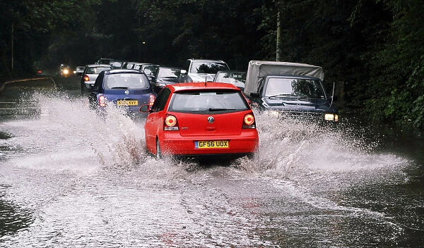 Cars driving through flash floods in Sevenoaks Kent