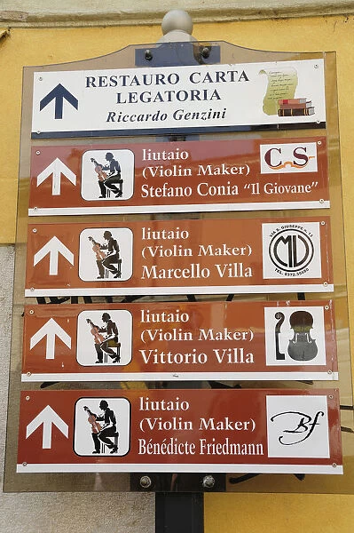Italy, Lombardy, Cremona, violin makers signs around city
