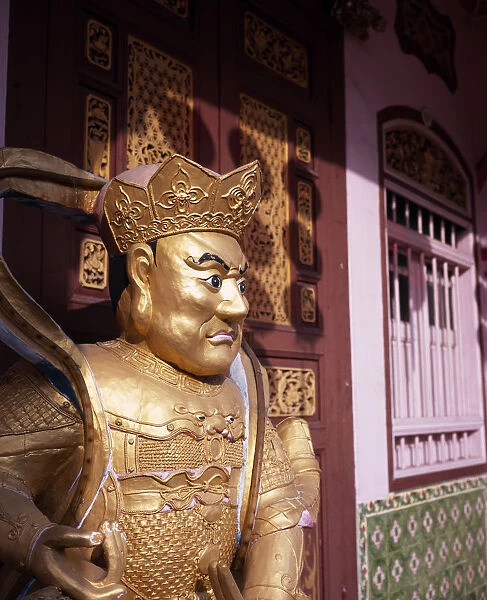 MALAYSIA, Penang, Georgetown Gold painted statue outside wholesaler shopfront during