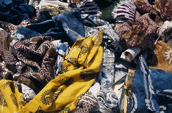 SENEGAL, Dakar Local dyed and printed fabrics for sale in market