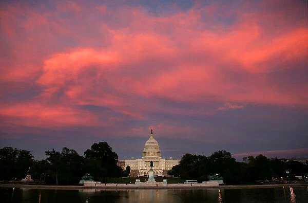 Clouds glow over the Capitol Building at sunset in Washington