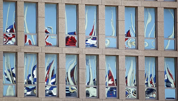 Cuban flags are reflected of the windows of the Interests Section Office of the United
