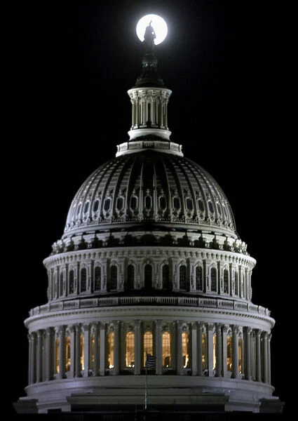 FULL MOON RISES BEHIND US CAPITOL DOME