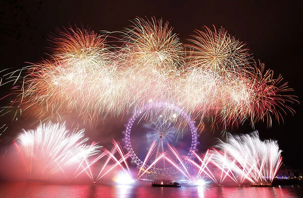 New Years fireworks explode around the London Eye in central London