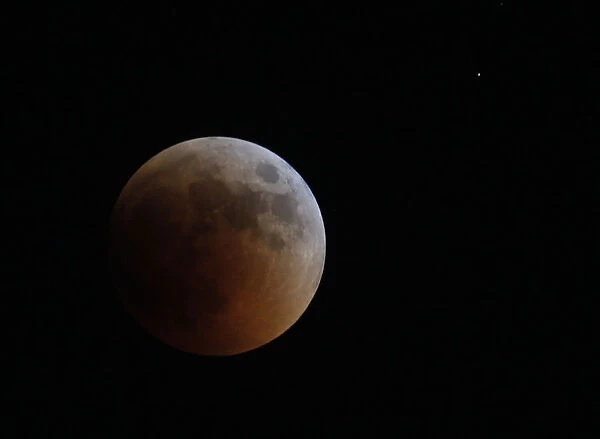 A shadow falls on the moon during a lunar eclipse as seen from Amman