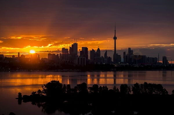 The sun rises over the skyline in Toronto