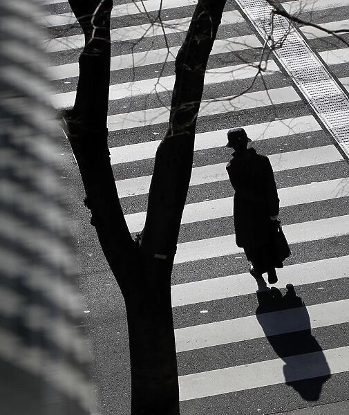 A woman crosses a street in Tokyo