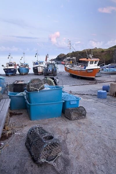 Fishing boats moored on shingle beach in evening sunlight, Cadgwith, Lizard Peninsula, Cornwall, England, August