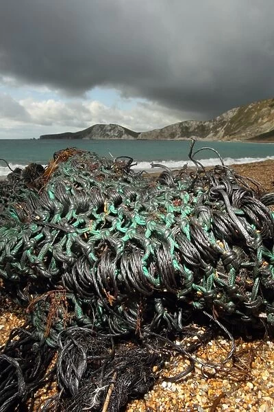 Oiled trawl net washed up on beach, Worbarrow Bay, Dorset, England, september