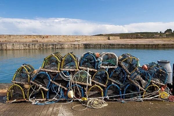 Pile of lobster pots stacked on quayside, Hopeman Harbour, Morayshire, Scotland, March