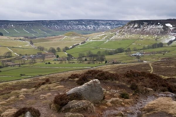 View of upland farmland and moorland habitat with patches of snow along drystone walls, looking from Danby Rigg