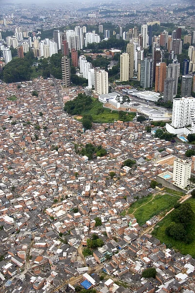 Aerial view of crowded favela housing contrasts with modern apartment buildings in Sao Paulo