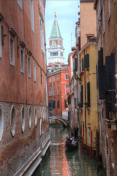 Belltower St. Marks Square seen through narrow canal, Venice Italy