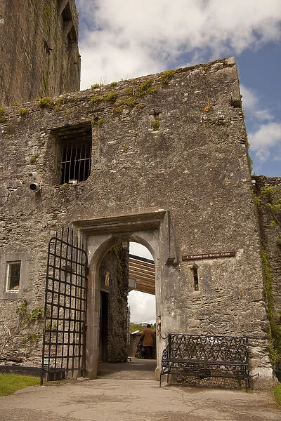 The Blarney Castle at the entranve to The Blarney Stone with a single tourist in