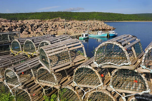 Canada, Nova Scotia, Neils Harbour. Boats and lobster traps in coastal village. Credit as
