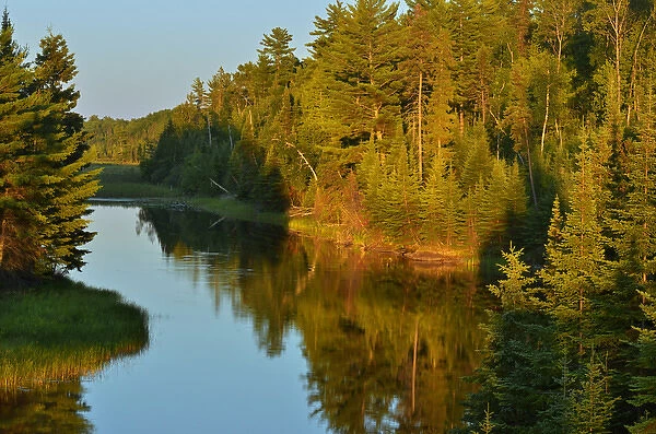 Canada, Ontario, Lake of the Woods. Sun setting on water at Reed Narrows. Credit as
