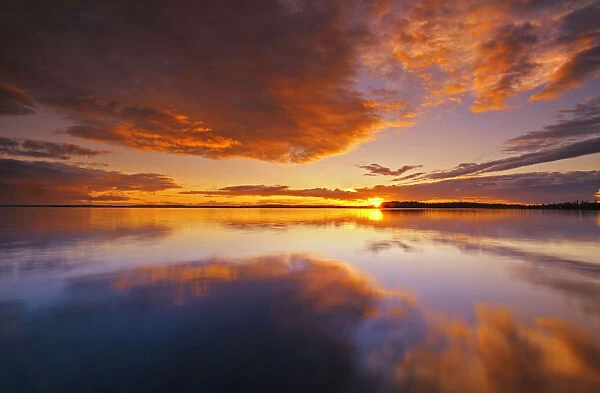Canada, Ontario, Pakwash Lake Provincial Park. Clouds reflected in Pakwash Lake at sunset