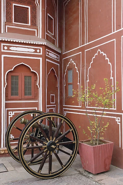 Canon in front of decorated wall, Amber Fort, Jaipur, India